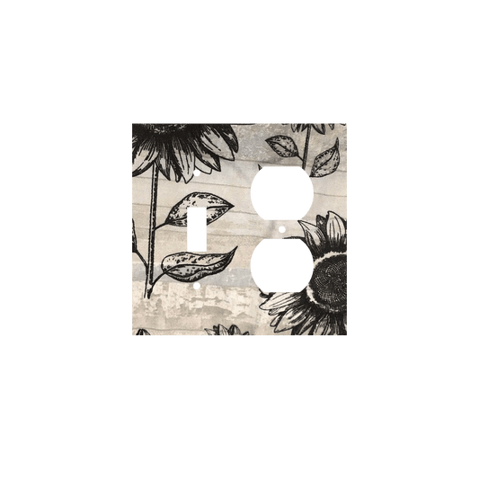 Handmade decorative light switch cover with bold black sunflowers on rustic beige woodgrain fabric, perfect for farmhouse and boho home décor
