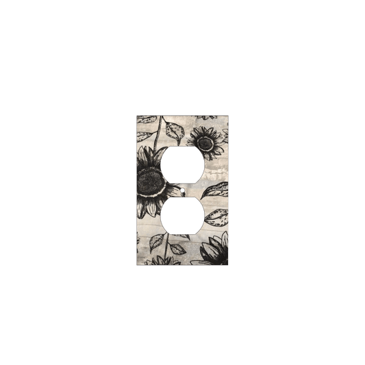 Handmade decorative light switch cover with bold black sunflowers on rustic beige woodgrain fabric, perfect for farmhouse and boho home décor