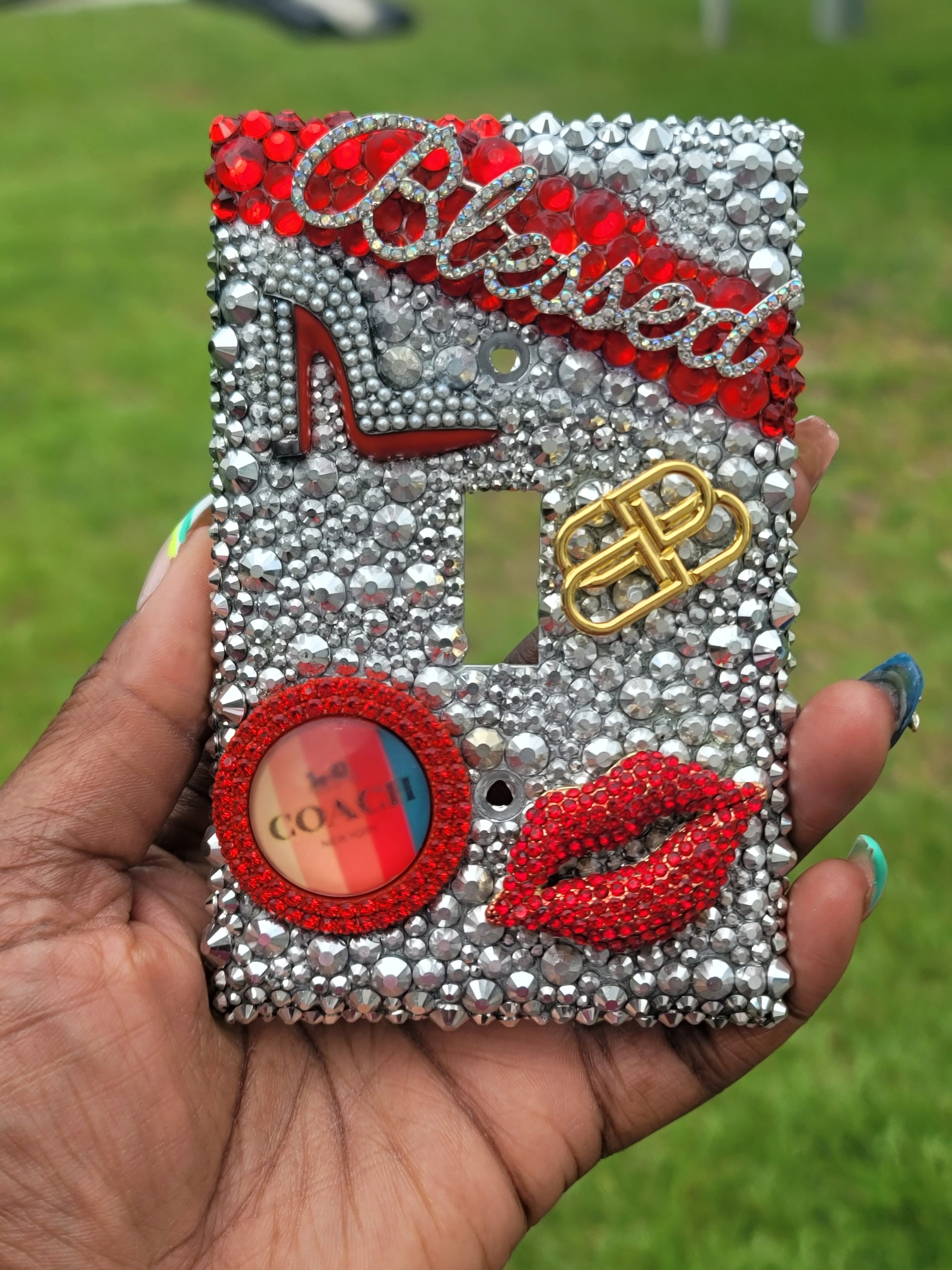 Handmade single toggle light switch cover with silver and red rhinestones featuring "Blessed" script, red-bottom heel, lips, designer chain emblem, and GOAL frame for glam fashion home décor
