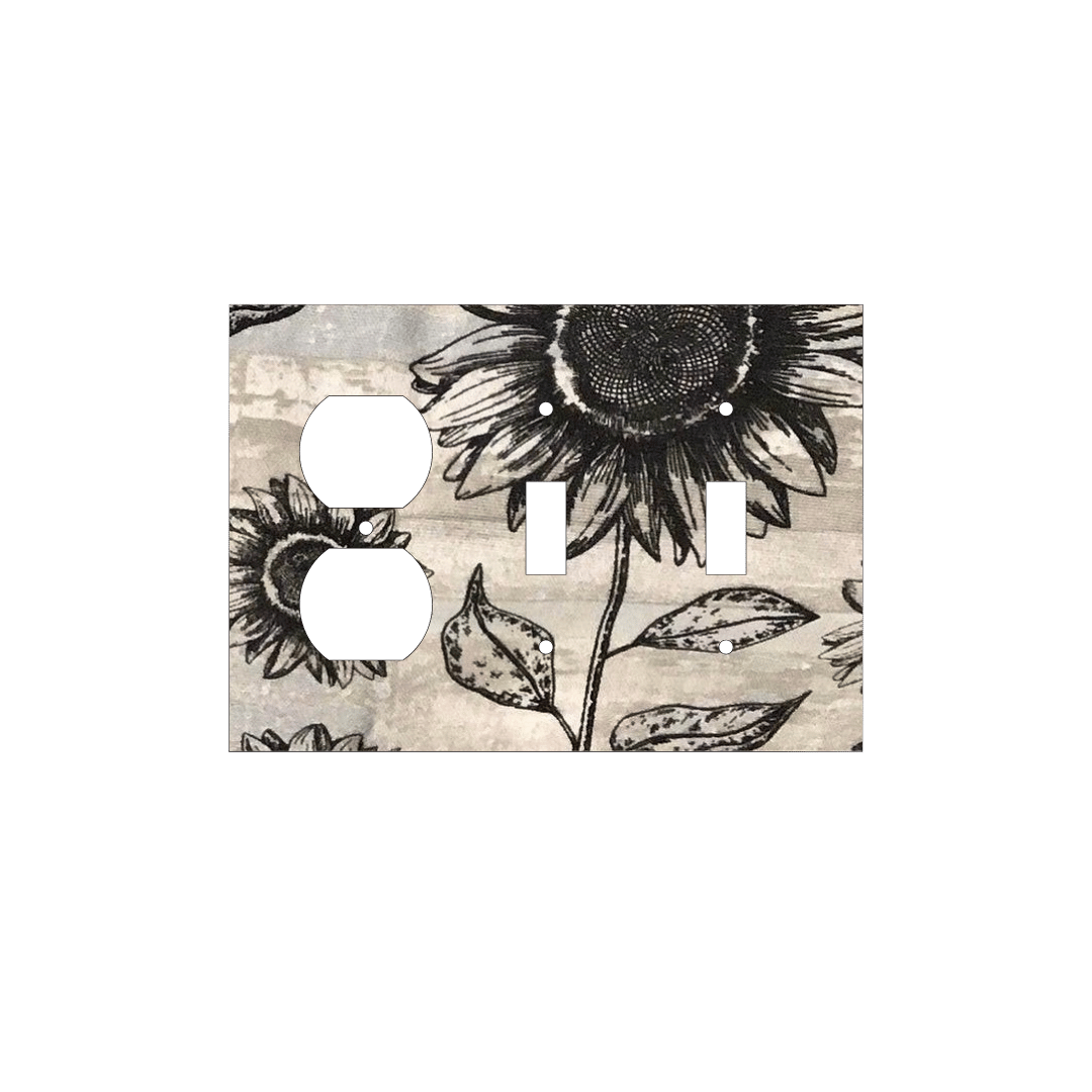 Handmade decorative light switch cover with bold black sunflowers on rustic beige woodgrain fabric, perfect for farmhouse and boho home décor