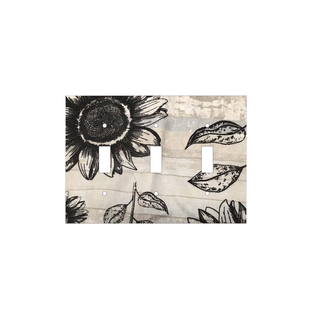 Handmade decorative light switch cover with bold black sunflowers on rustic beige woodgrain fabric, perfect for farmhouse and boho home décor