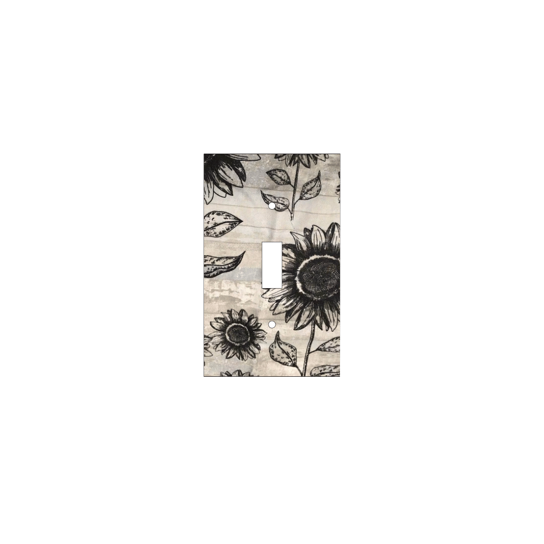 Handmade decorative light switch cover with bold black sunflowers on rustic beige woodgrain fabric, perfect for farmhouse and boho home décor