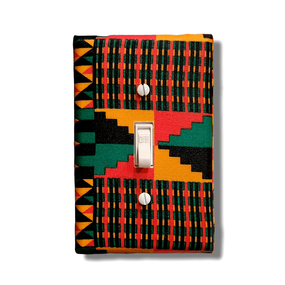 Handmade light switch cover with kente-inspired stepped staircase pattern in forest green, vibrant red, golden orange, and black featuring traditional African ascent symbolism and vertical weaving stripes for cultural heritage home décor