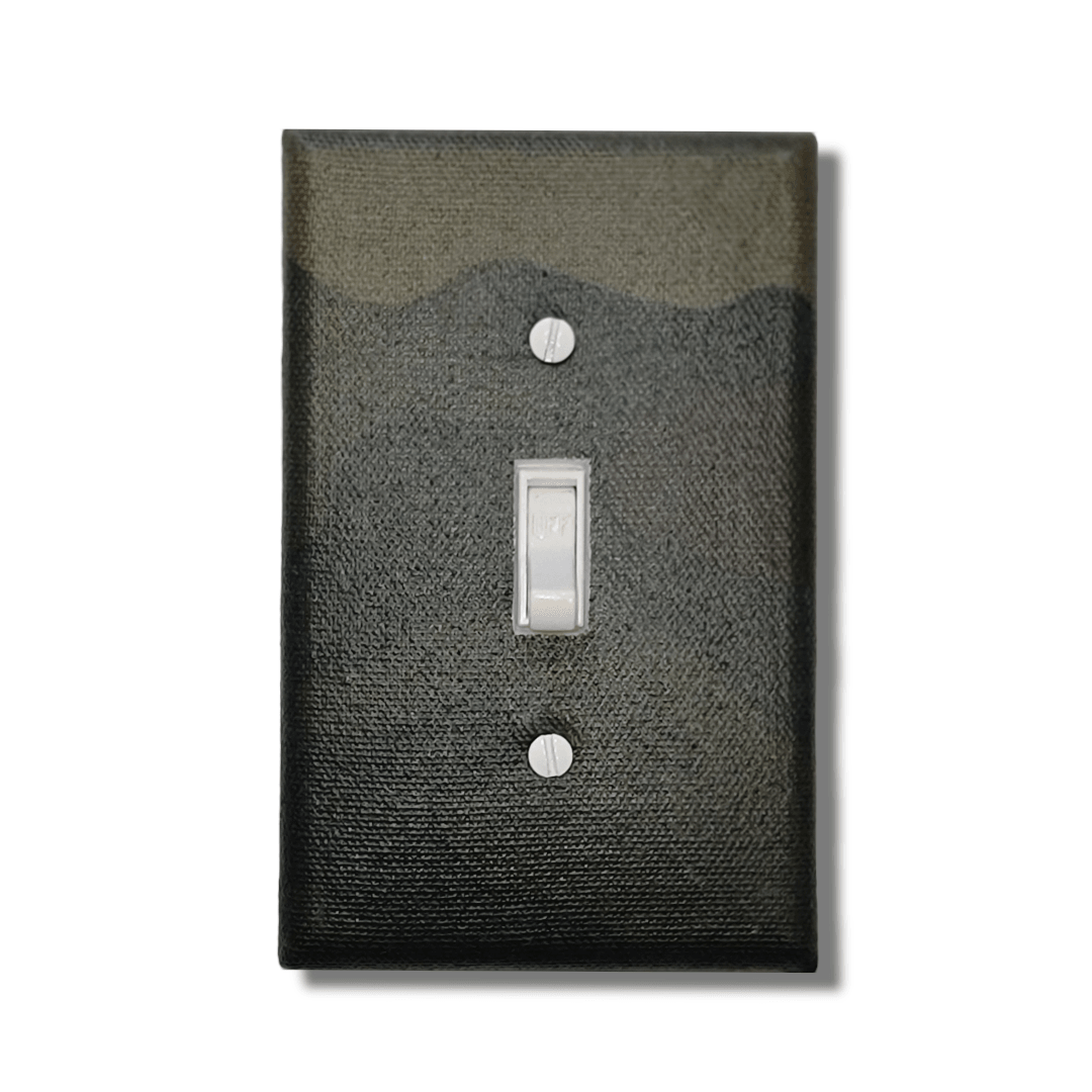 Handmade Outdoor Combat Legacy decorative light switch cover featuring green and brown woodland camouflage pattern—military and hunting switch plates from Black-owned home décor.