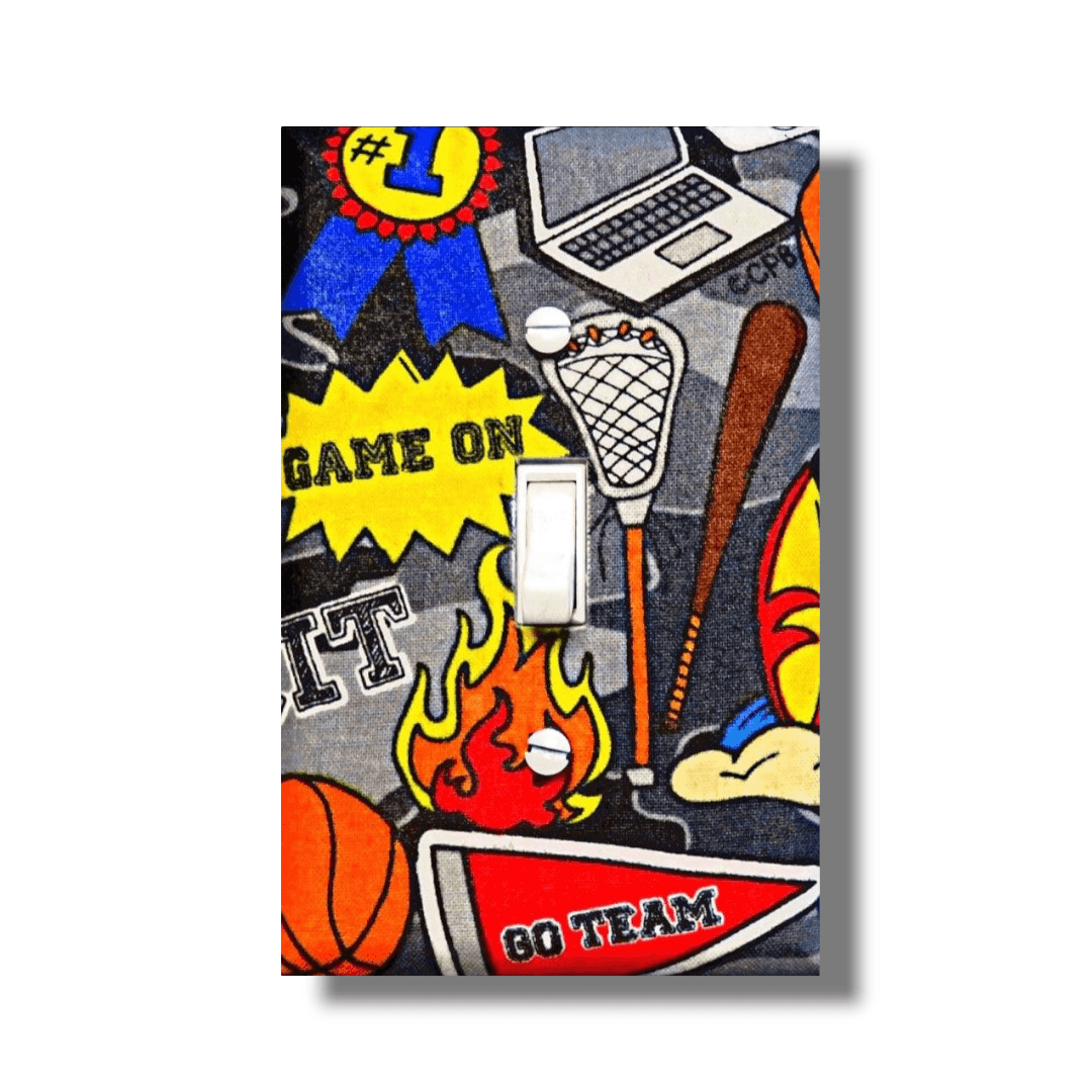 Handmade Game On Athletic Energy decorative light switch cover featuring basketball, baseball bat, lacrosse stick, #1 medal, and Game On text on gray background—multi-sport switch plates from Black-owned home décor.
