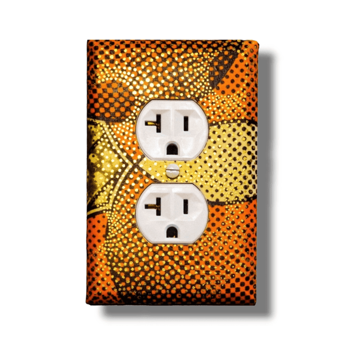 Handmade single outlet light switch cover with intricate dot pattern in golden honey, burnt orange, cream, and black creating curved pathways for sophisticated earth-tone home décor
