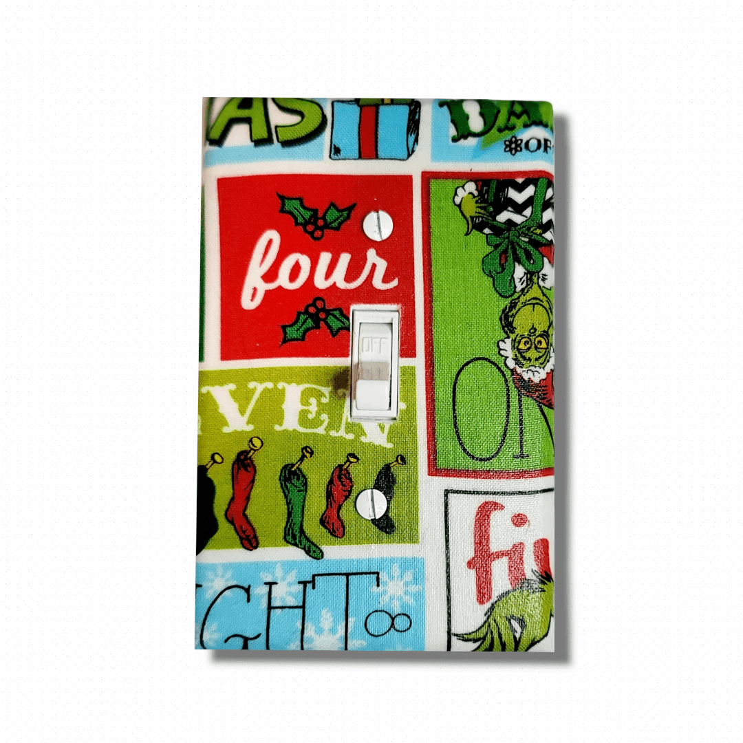 Handmade The Grinch Holiday Spirit decorative light switch cover featuring the Grinch with retro comic panel style and holiday text—officially licensed Dr. Seuss switch plates from Black-owned home décor.
