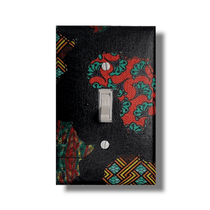 African continent single light switch cover featuring Kente and Ankara collage fabrics on deep navy blue base, handmade wall décor. -Kustom Kreationz by Kila