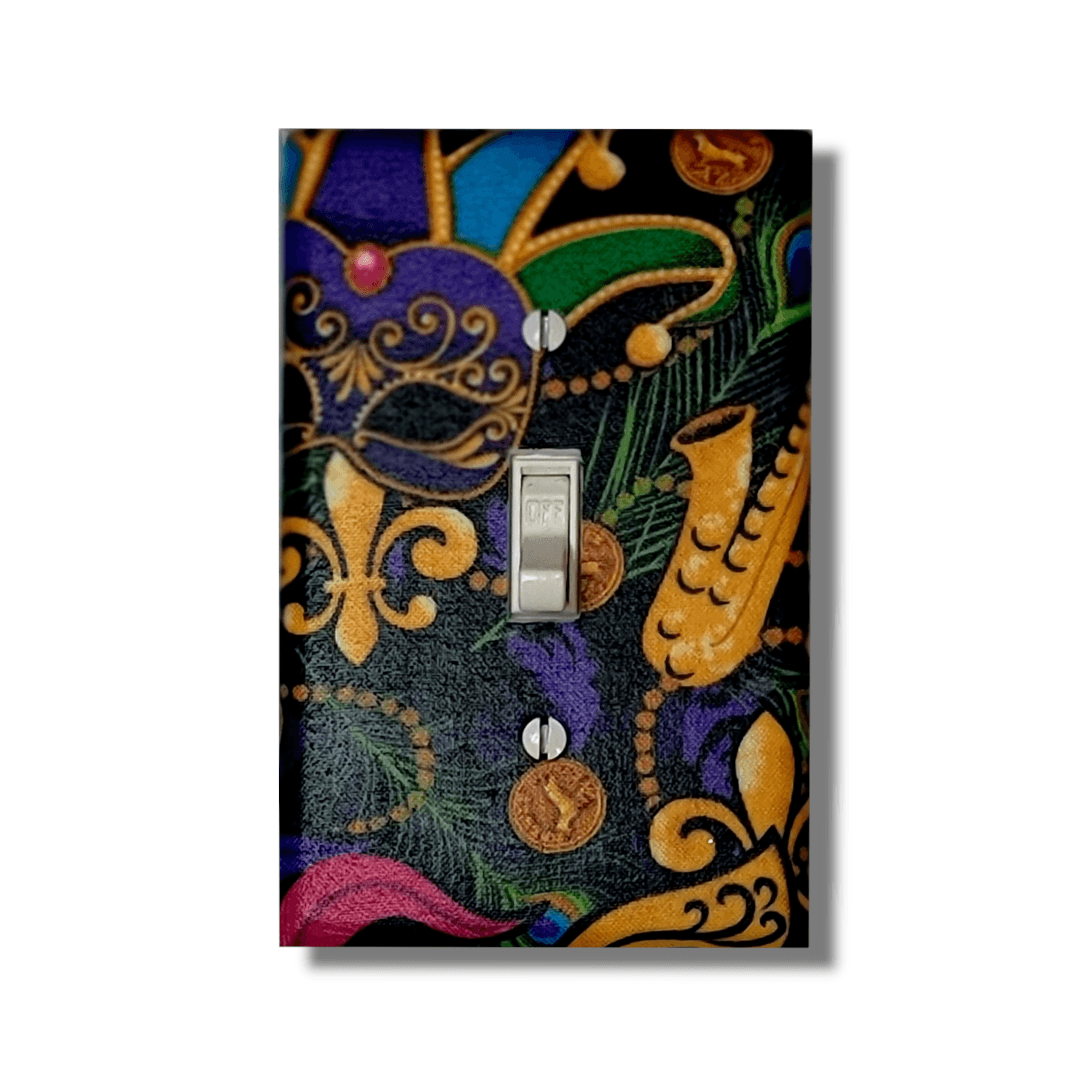Handmade Mardi Gras Masquerade decorative light switch plate featuring ornate purple mask, fleur-de-lis, saxophone, and beads in purple, green, and gold—New Orleans switch plates from Black-owned home décor.