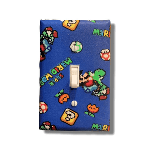 Handmade Super Mario World 8-Bit decorative light switch cover featuring retro pixel art with Yoshi, question blocks, mushrooms on bright blue background—officially licensed Nintendo switch plates from Black-owned home décor.