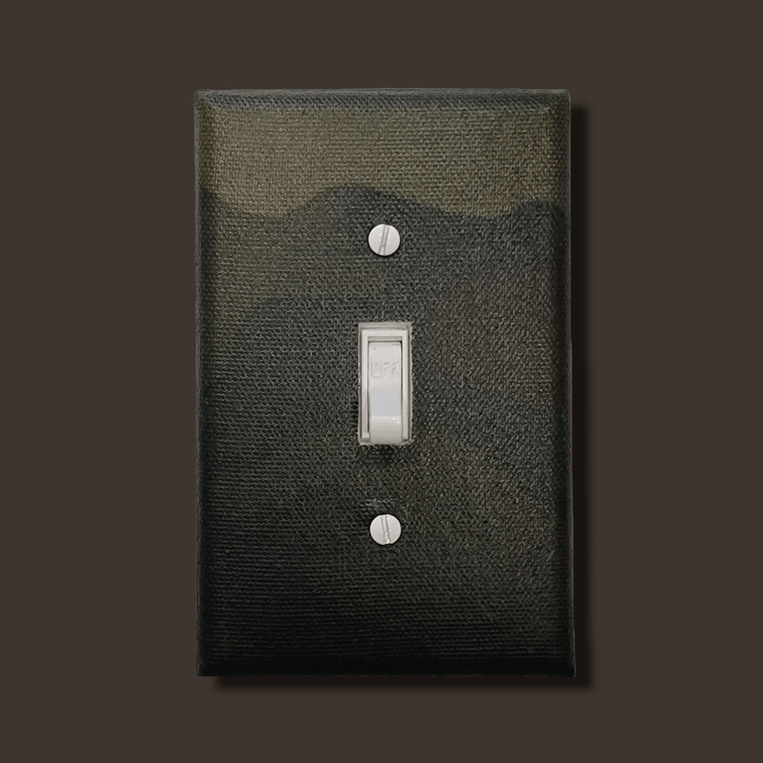 Handmade Outdoor Combat Legacy decorative light switch cover featuring green and brown woodland camouflage pattern—military and hunting switch plates from Black-owned home décor.