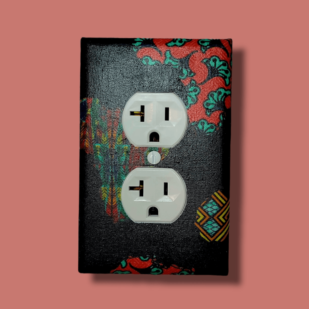African continent single light switch cover featuring Kente and Ankara collage fabrics on deep navy blue base, handmade wall décor. -Kustom Kreationz by Kila