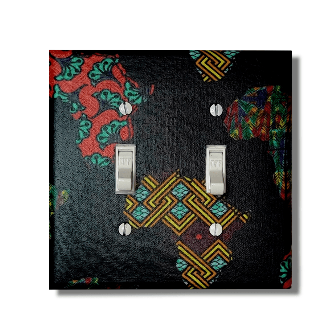 African continent double light switch cover featuring Kente and Ankara collage fabrics on deep navy blue base, handmade wall décor.