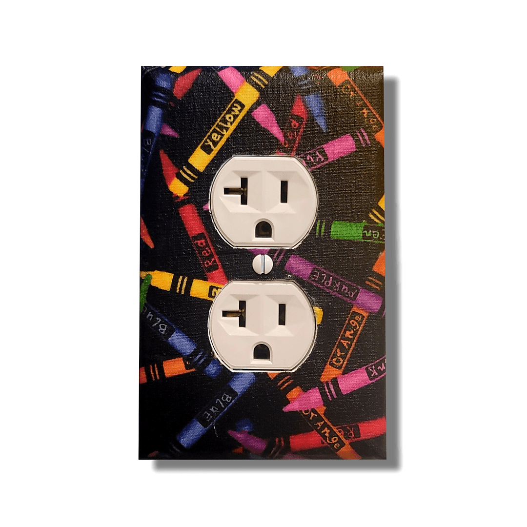 Handmade Color Outside the Lines Crayon Craft decorative light switch cover featuring scattered colorful crayons on black background—art room switch plates from Black-owned home décor.