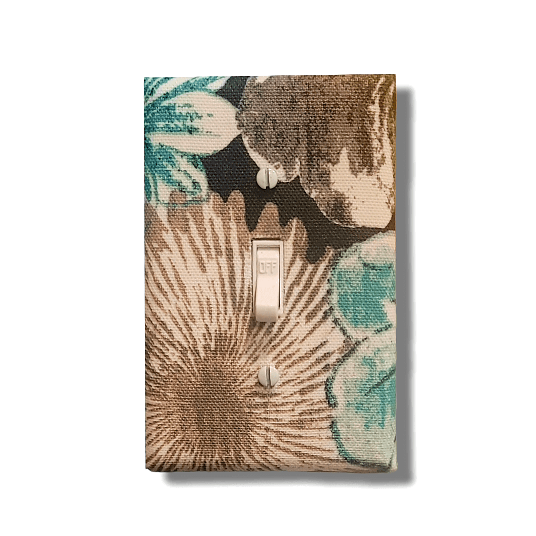 Palm breeze fabric switch cover with teal-green and cream palm fronds on tropical print, available in all configurations, handmade by Black-owned Kustom Kreationz by Kila
