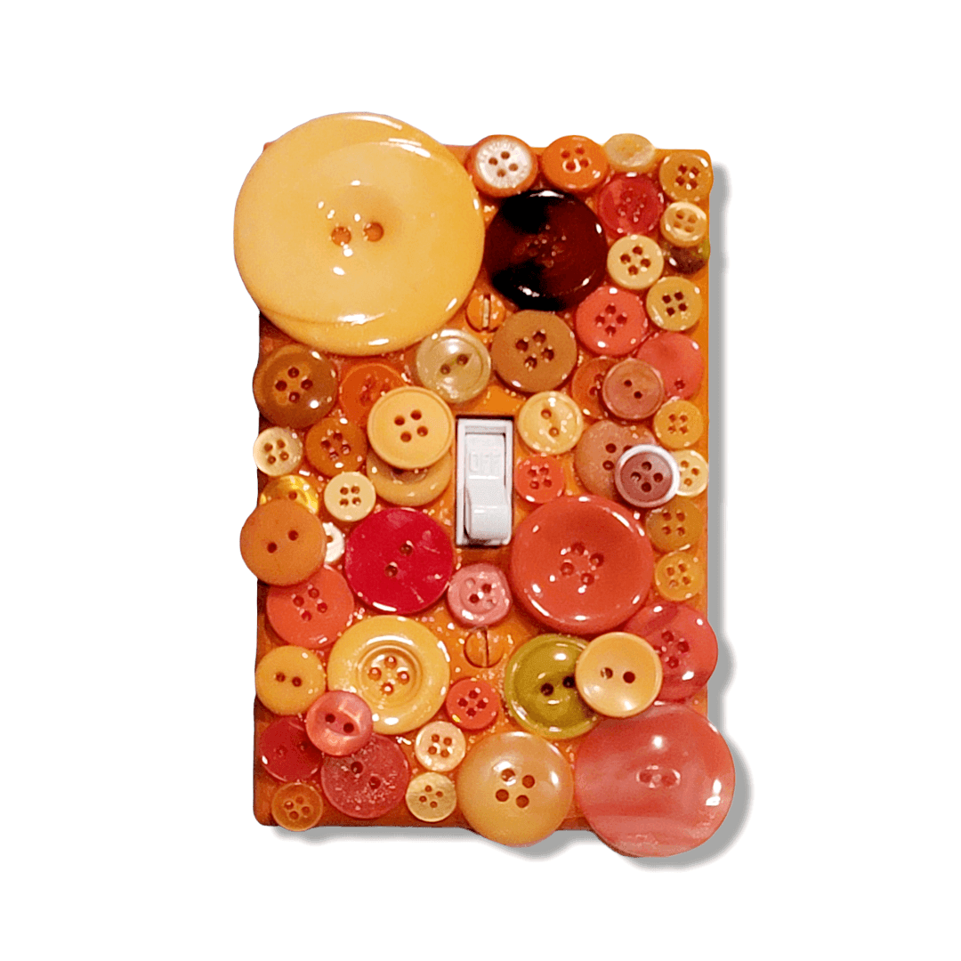 Marigold mix button mosaic decorative switch plate with translucent and glossy buttons in golden yellow, burnt orange, coral and terracotta tones, handmade by Black-owned Kustom Kreationz by Kila